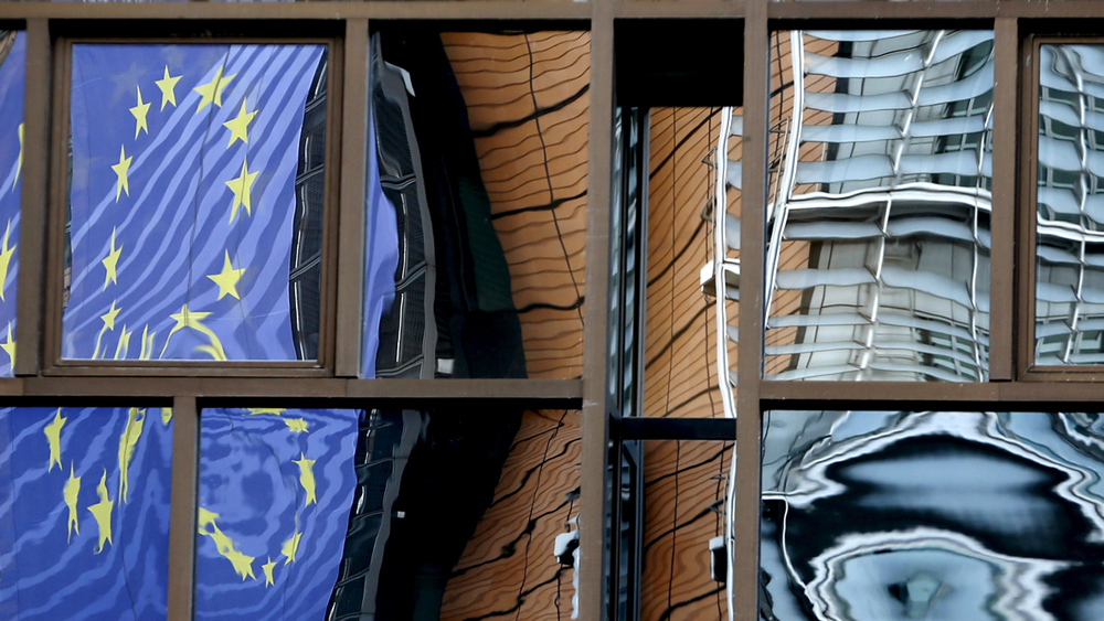 The facade of the European Commission headquarters is reflected in the windows of the EU Council building in Brussels, Belgium, May 20, 2015. REUTERS/Francois Lenoir - RTX1DT61