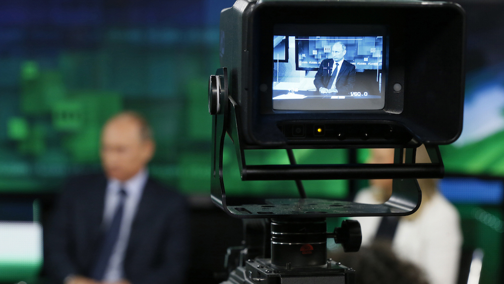 Russian President Vladimir Putin is seen on the screen of a television camera during his visit to the new studio complex of television channel 'Russia Today' in Moscow June 11, 2013. Russian President Vladimir Putin said on Tuesday he has no doubt that Iran is adhering to international commitments on nuclear non-proliferation but regional and international concerns about Tehran's nuclear programme could not be ignored. REUTERS/Yuri Kochetkov/Pool (RUSSIA - Tags: POLITICS) - RTX10K2Q