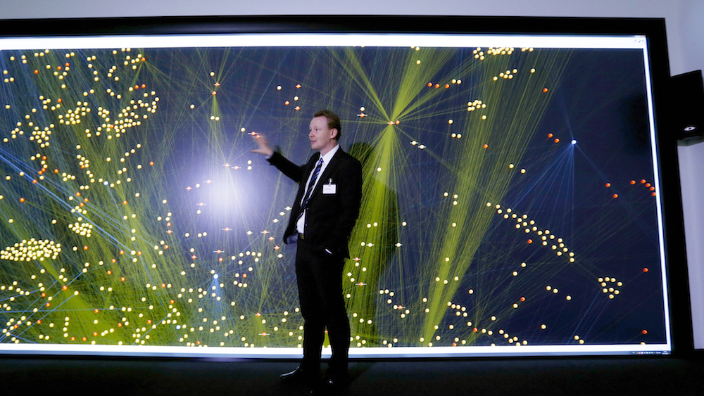 Employee Lothar Baum explains how a 'Data Mining' 12 million pixel wide screen works before the BOSCH's official opening ceremony of the company's new center for research and advance engineering Campus Renningen in Renningen, Germany, October 14, 2015. REUTERS/Michaela Rehle - RTS4ESW