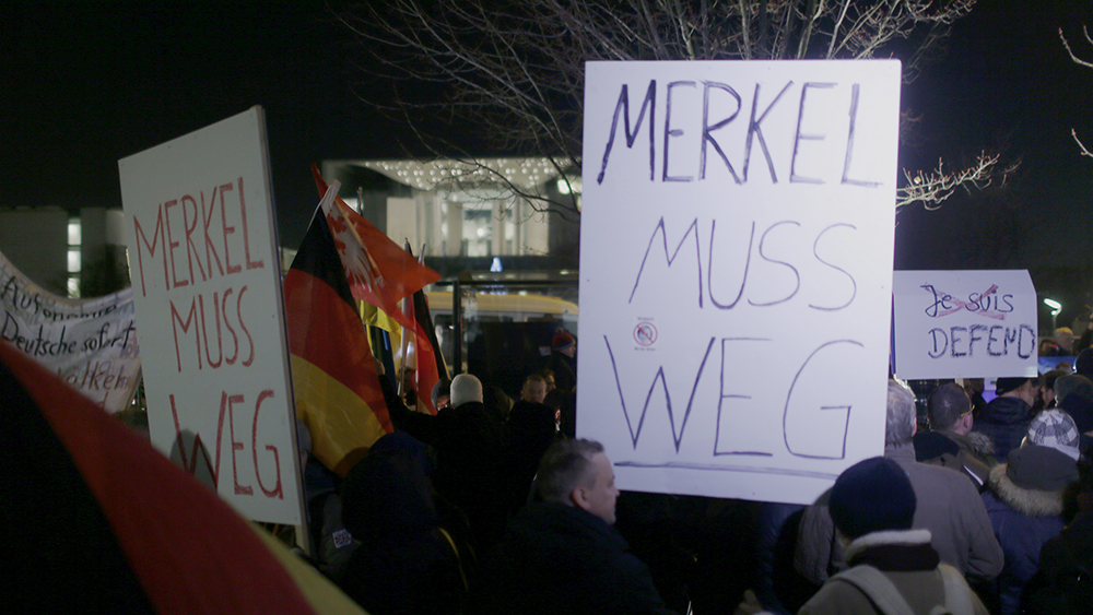 Anti-immigration party Alternative for Germany (AfD) supporters hold placards reading"Merkel must go" to demonstrate against German Chancellor Angela Merkel's migrant policy in front of the chancellery in Berlin, Germany, December 21, 2016, after a truck ploughed through a crowd at a Christmas market in the captial on Monday night. REUTERS/Hannibal Hanschke - RTX2W1ZW